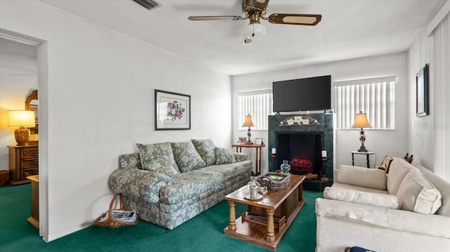 carpeted living room with a wealth of natural light and ceiling fan