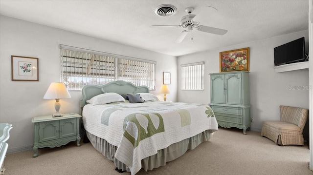 bedroom featuring multiple windows, light carpet, and ceiling fan