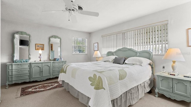 bedroom with light colored carpet and ceiling fan