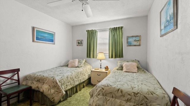 bedroom featuring ceiling fan, carpet flooring, and a textured ceiling