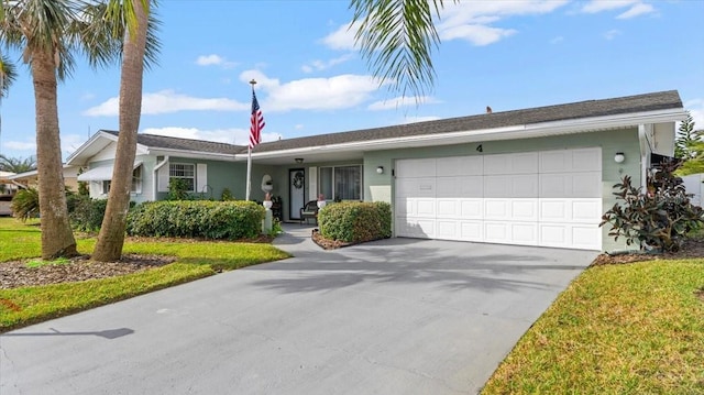 ranch-style home featuring a garage and a front lawn