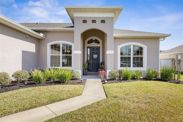 property entrance featuring a lawn