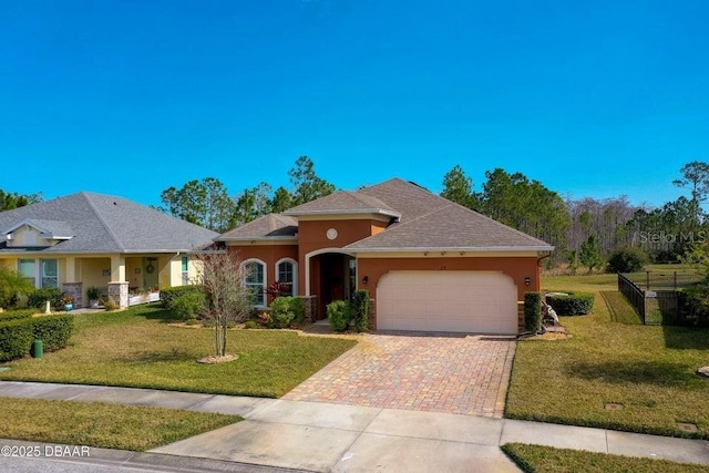 view of front of property with a garage and a front lawn