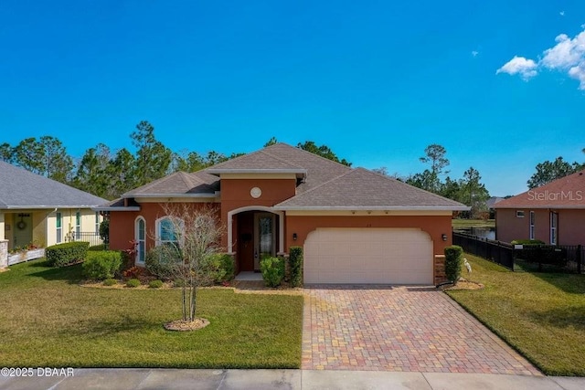 view of front of property featuring a garage and a front yard