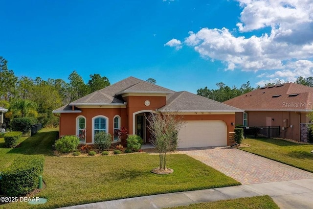 view of front of house featuring a garage and a front yard