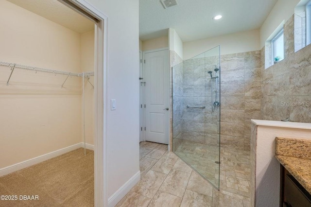 bathroom featuring vanity and a tile shower