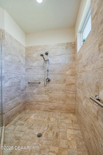 bathroom with tiled shower