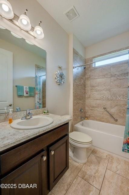 full bathroom with shower / tub combo with curtain, vanity, tile patterned flooring, and toilet