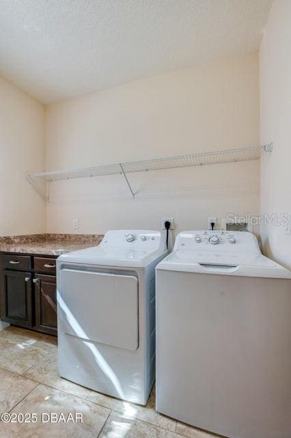 laundry area featuring cabinets and independent washer and dryer