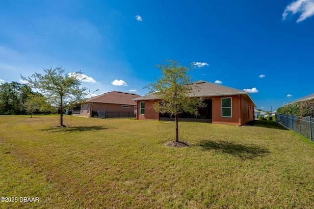 rear view of property featuring a lawn