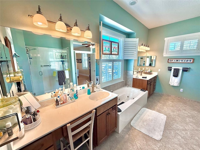 bathroom featuring a stall shower, ceiling fan, a jetted tub, a sink, and two vanities