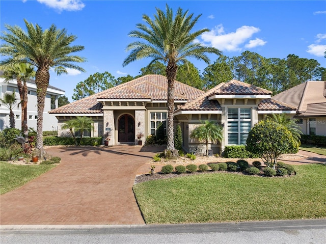 mediterranean / spanish house with a front lawn