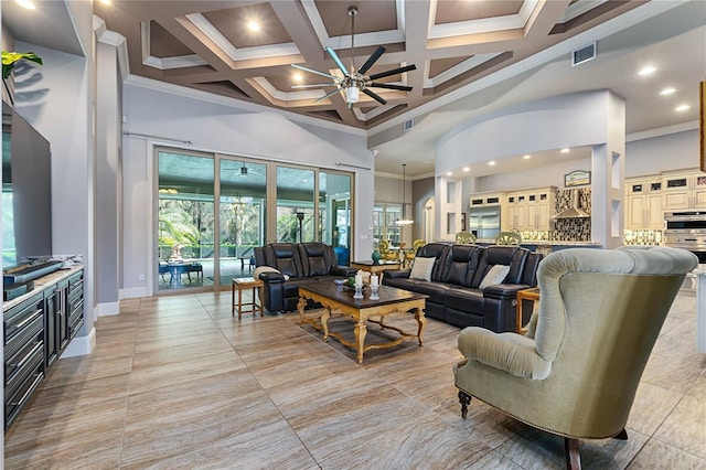 living room featuring a high ceiling, ornamental molding, coffered ceiling, and ceiling fan