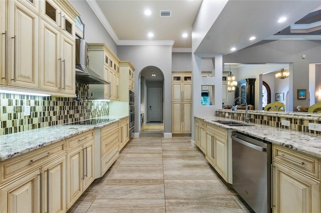 kitchen featuring wall chimney exhaust hood, sink, pendant lighting, stainless steel appliances, and light stone countertops