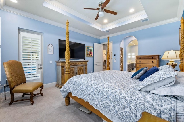 bedroom featuring crown molding, light colored carpet, a raised ceiling, and ceiling fan