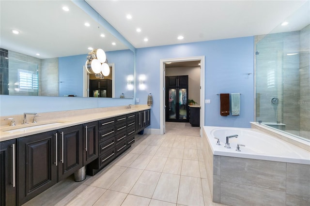 bathroom featuring tile patterned floors, vanity, and independent shower and bath