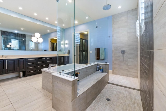 bathroom featuring vanity, tile patterned flooring, and plus walk in shower