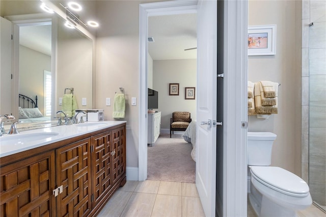 bathroom with vanity, tile patterned floors, and toilet