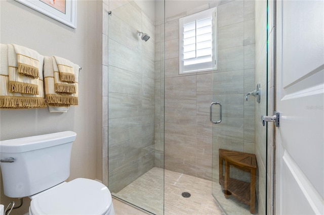 bathroom with toilet and an enclosed shower