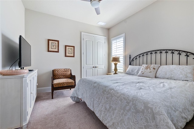 carpeted bedroom with ceiling fan and a closet