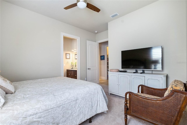 carpeted bedroom with connected bathroom and ceiling fan