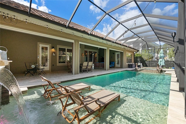 view of swimming pool featuring an in ground hot tub, glass enclosure, and a patio