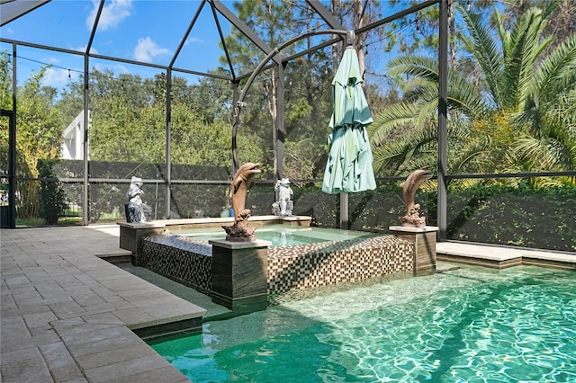 view of swimming pool with a hot tub, a patio area, and a lanai