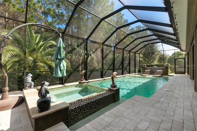 view of swimming pool featuring a patio, glass enclosure, and an in ground hot tub