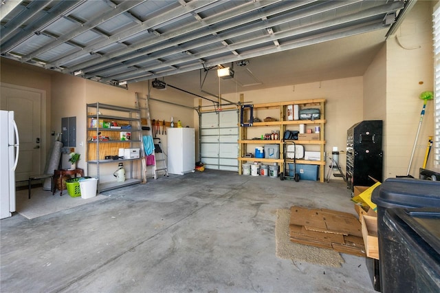 garage featuring a garage door opener, electric panel, and white fridge