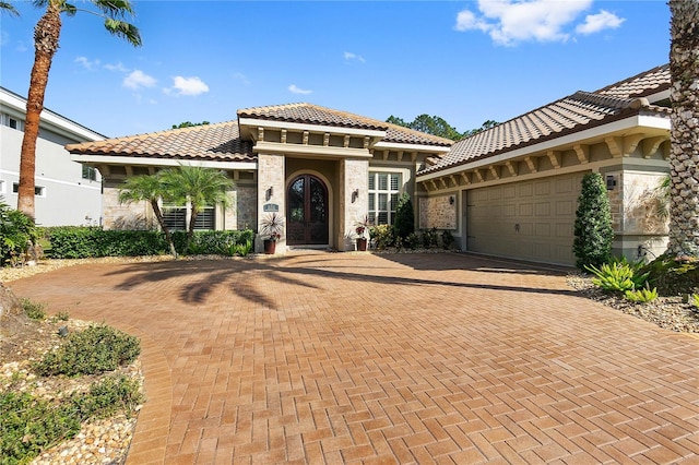 mediterranean / spanish house with a garage