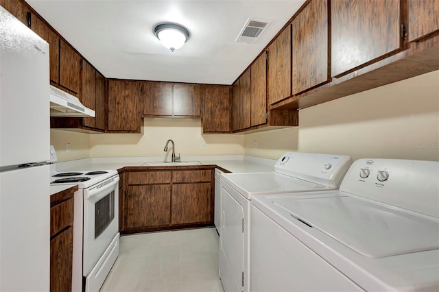 48 Club House Dr Unit 106, Palm Coast, FL 32137 - washroom with washing machine and dryer, a sink, laundry area, light tile patterned floors, and visible vents