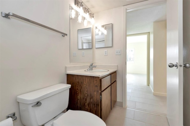 48 Club House Dr Unit 106, Palm Coast, FL 32137 - bathroom featuring toilet, vanity, and tile patterned flooring