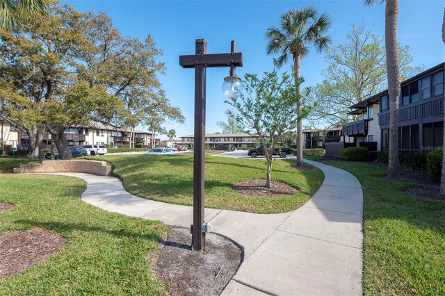 48 Club House Dr Unit 106, Palm Coast, FL 32137 - surrounding community with a residential view and a yard