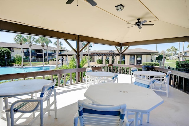 48 Club House Dr Unit 106, Palm Coast, FL 32137 - view of patio with outdoor dining area, fence, ceiling fan, and a community pool
