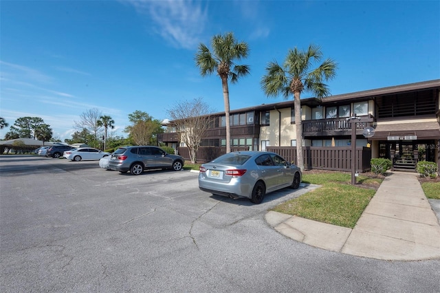 48 Club House Dr Unit 106, Palm Coast, FL 32137 - view of property with fence and uncovered parking