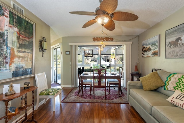 dining area with ceiling fan, dark hardwood / wood-style floors, and a textured ceiling