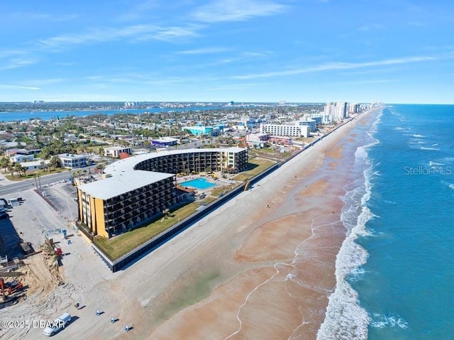 drone / aerial view featuring a view of the beach and a water view