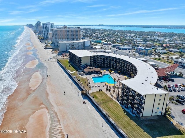 bird's eye view with a water view and a beach view