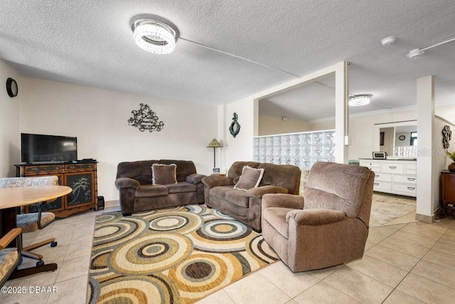 tiled living room with ornamental molding and a textured ceiling