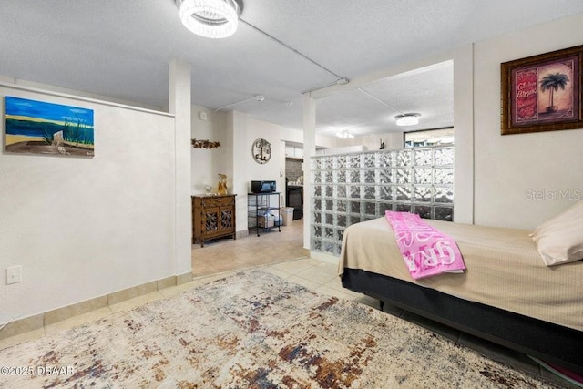 tiled bedroom with a textured ceiling