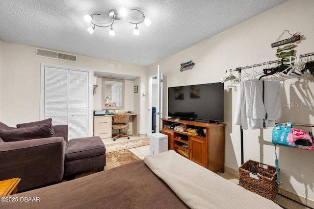 living room featuring light tile patterned floors and a textured ceiling