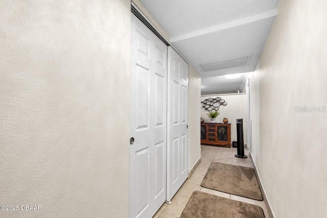 hall featuring light tile patterned flooring