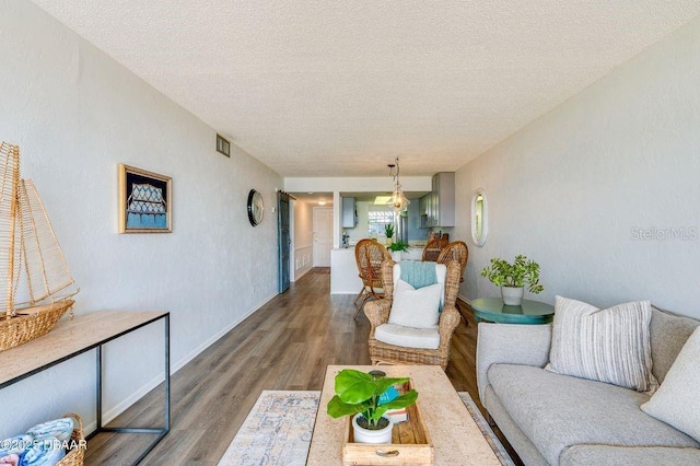 living room with hardwood / wood-style flooring and a textured ceiling