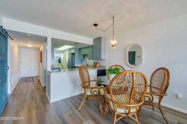 dining room featuring dark hardwood / wood-style flooring, sink, and a textured ceiling