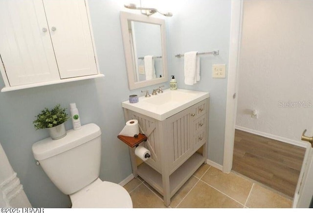 bathroom featuring vanity, toilet, and tile patterned flooring