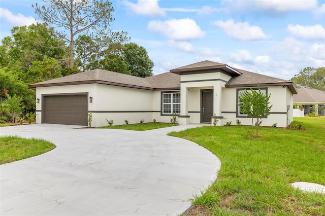 prairie-style home featuring a garage and a front yard