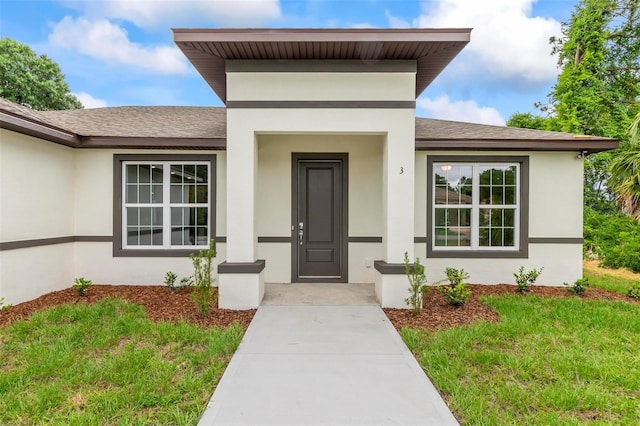 doorway to property with a yard