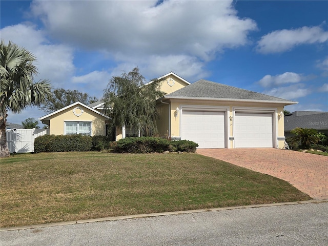 ranch-style house with a garage and a front yard