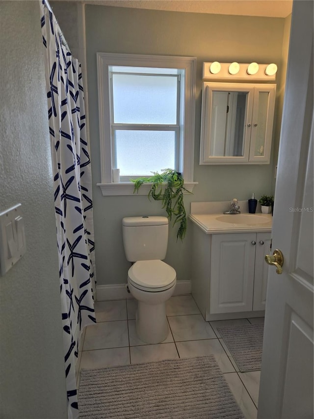 bathroom with walk in shower, tile patterned floors, vanity, and toilet