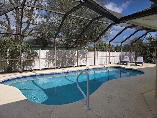 view of swimming pool with a lanai and a patio area